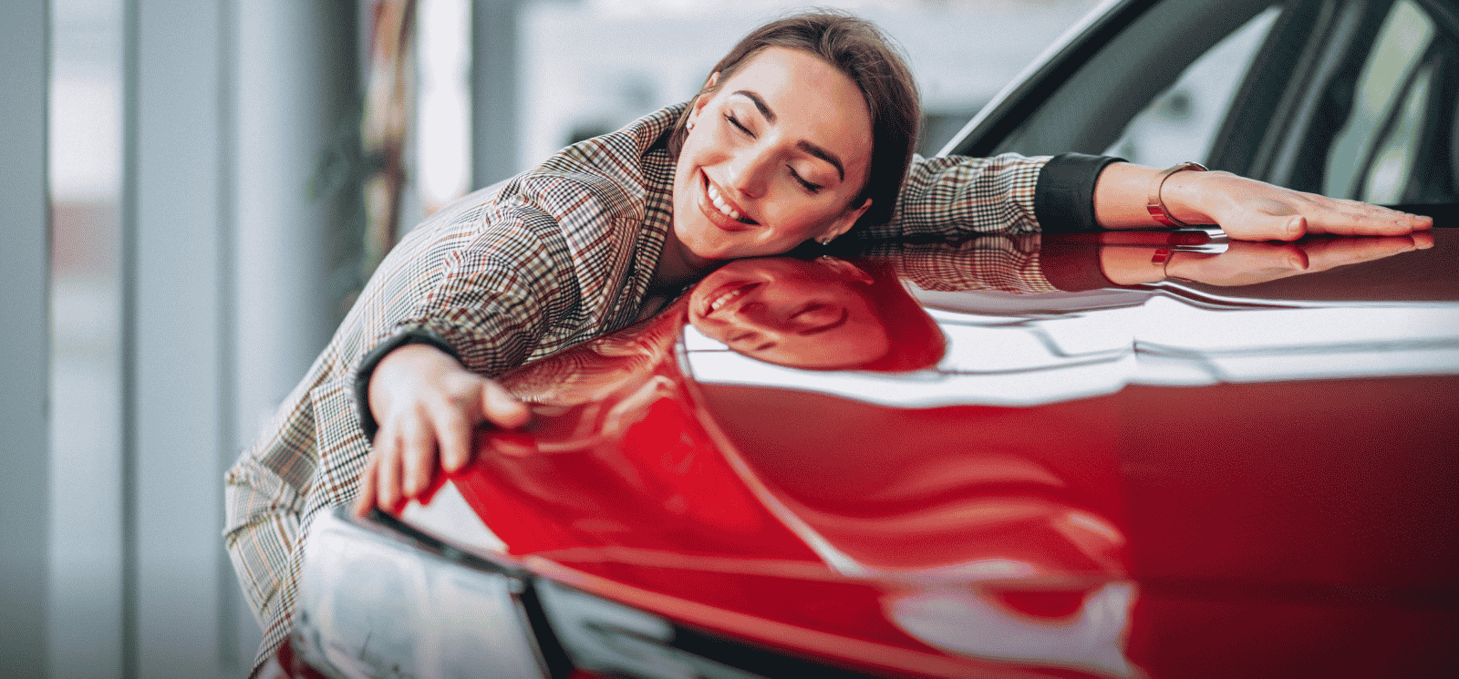 woman hugging new car
