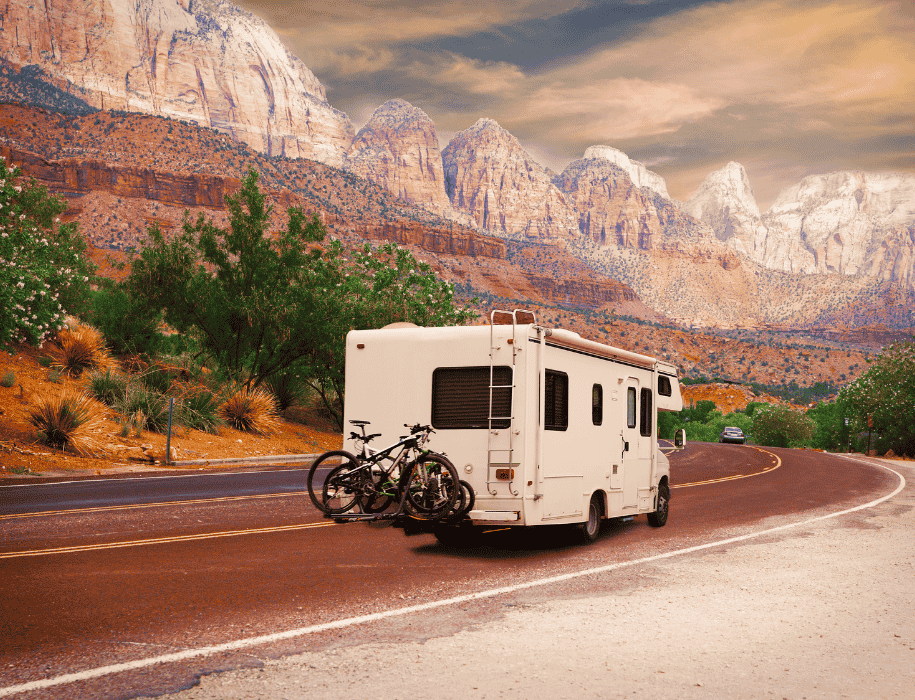 Camper on road with hills in distance
