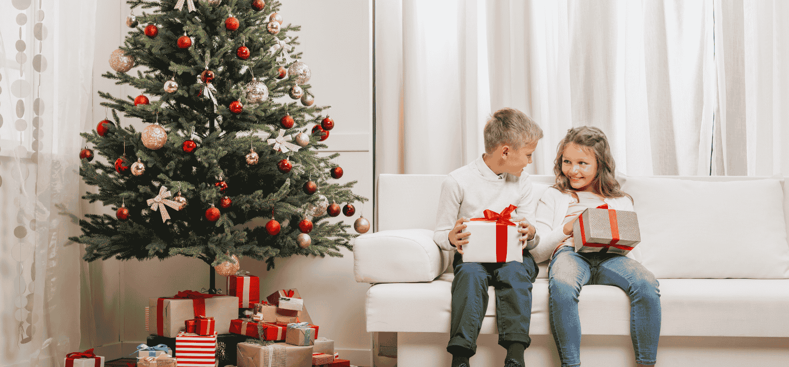 Kids on couch with christmas gifts