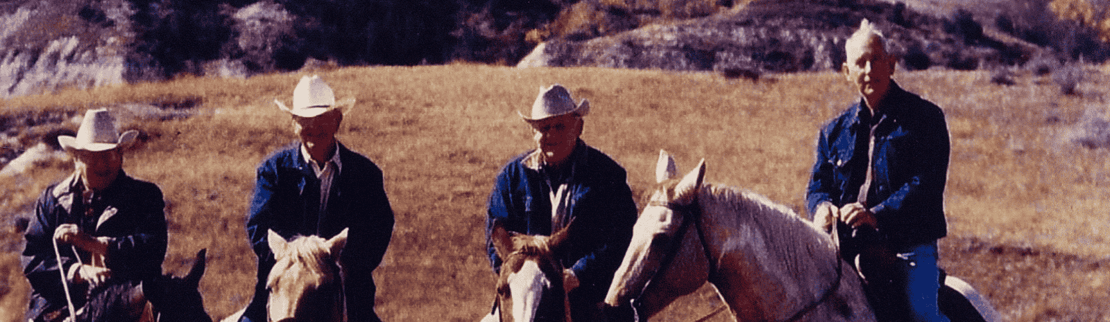 Four cowboys on horses in the North Dakota badlands