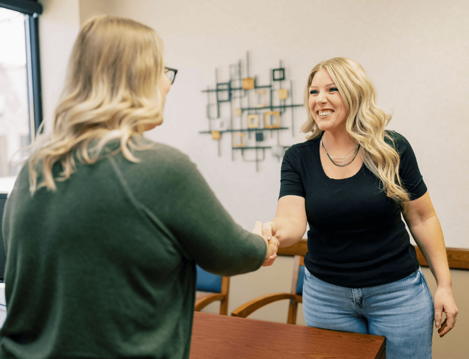 Lender shaking hands with customer