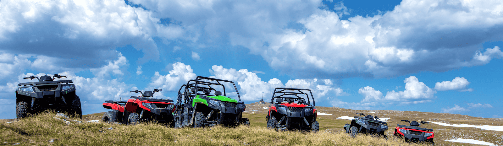 6 ATVs parked on grassy hill
