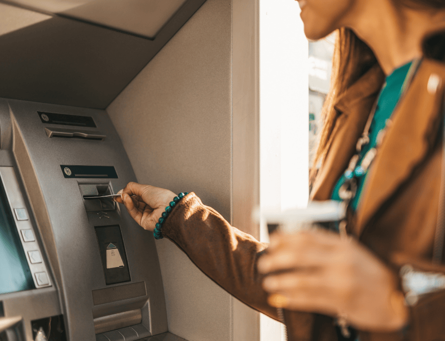 Woman using card at atm
