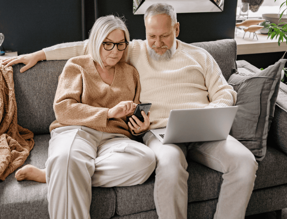 Couple sitting on couch looking at mobile devices
