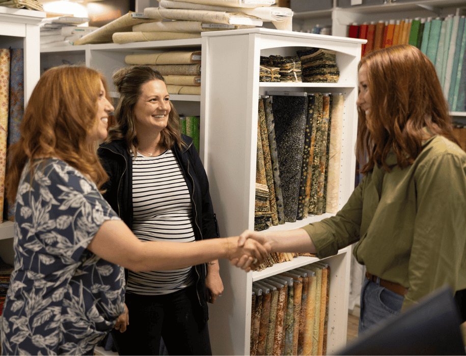 lender shakes hands with business owner