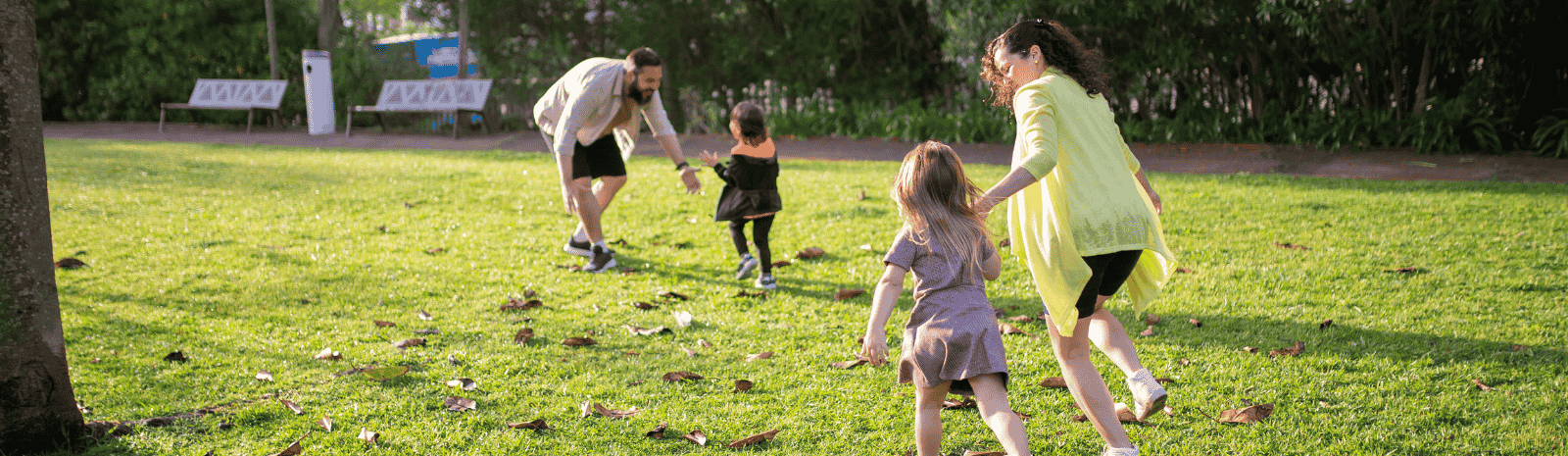 A Family Playing on the Green Grass Field