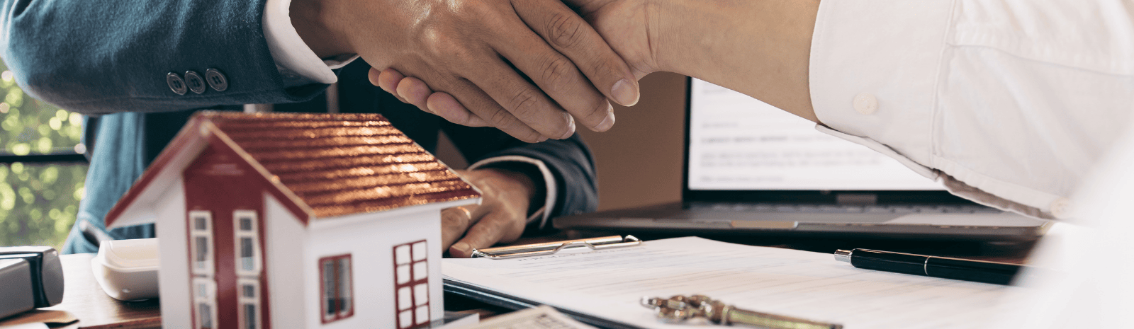Two people shaking hands after real estate purchase
