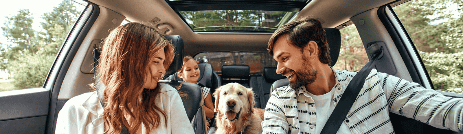 Family in car with dog